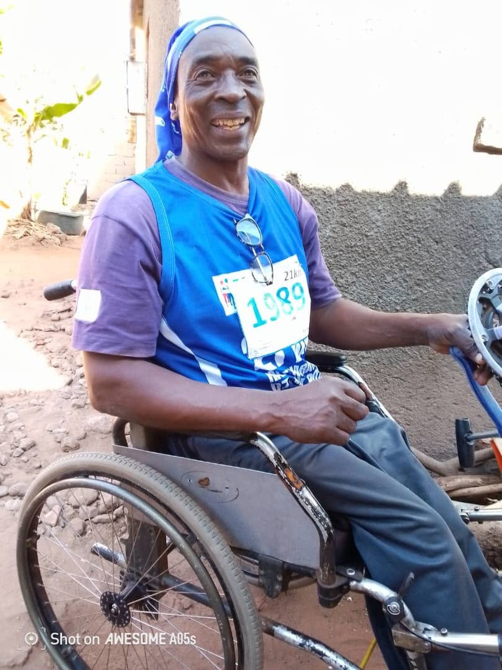 A wheelchair athlete smiles on his hand-cycle
