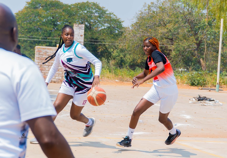 A player drives the basketball past a defender