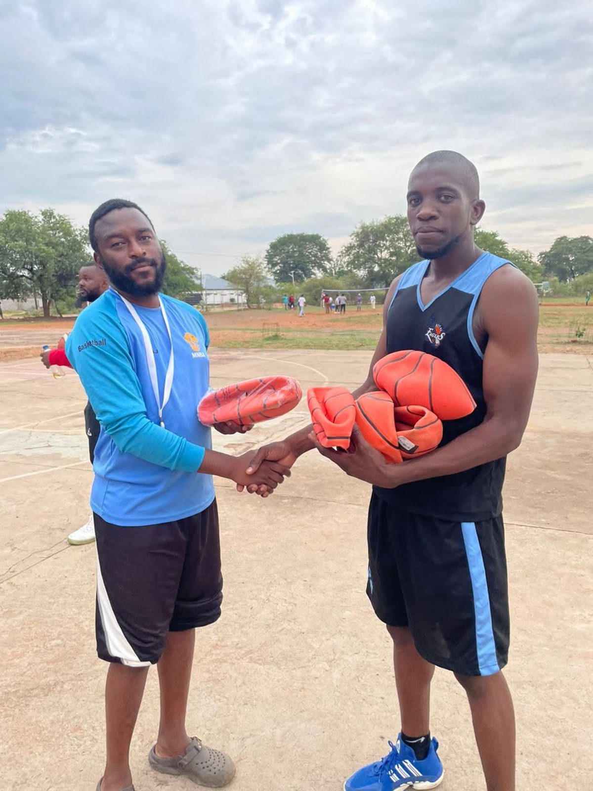 MNBA hands basketballs to a club