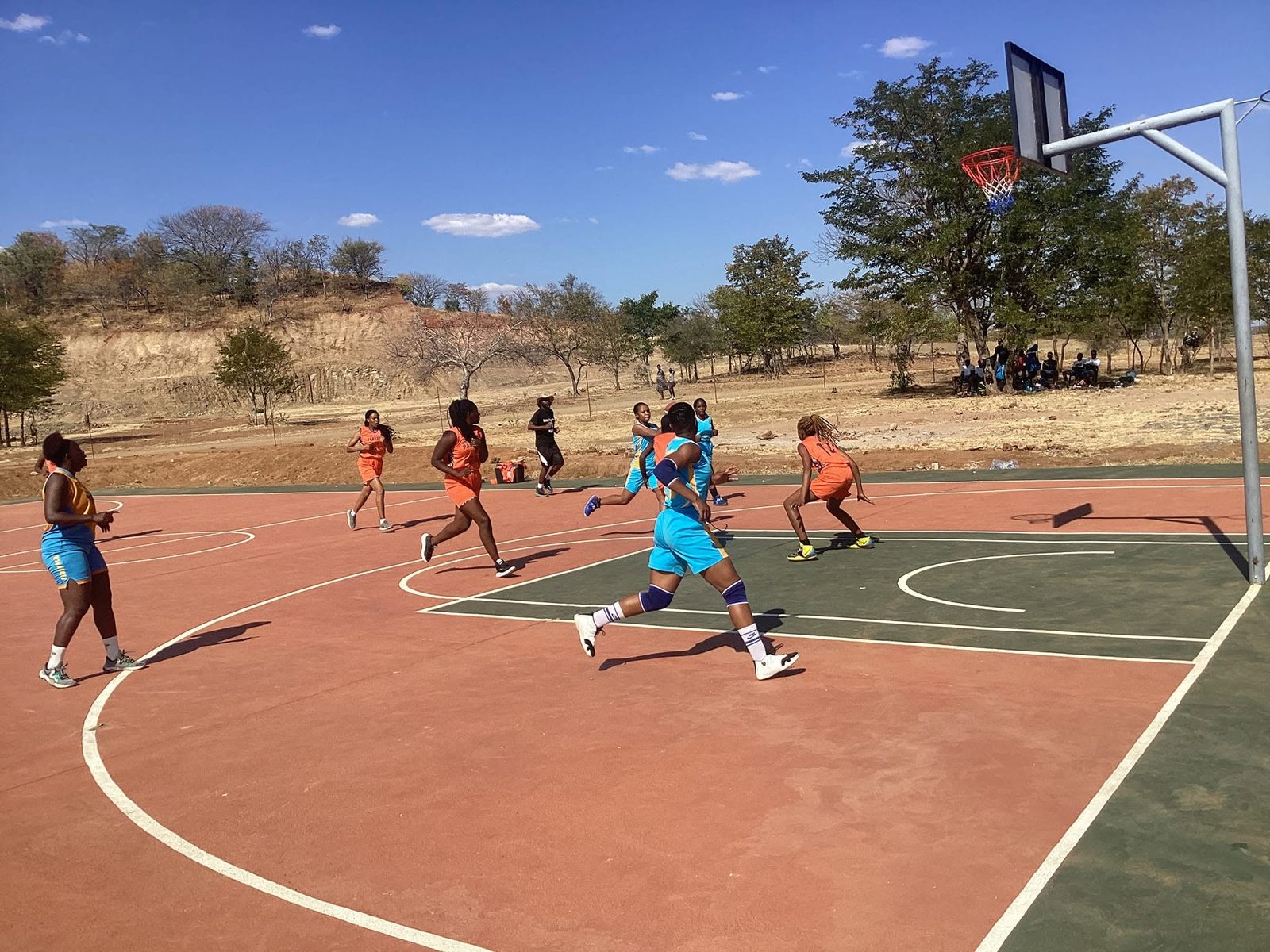 Women's game in full flow on an outdoor court