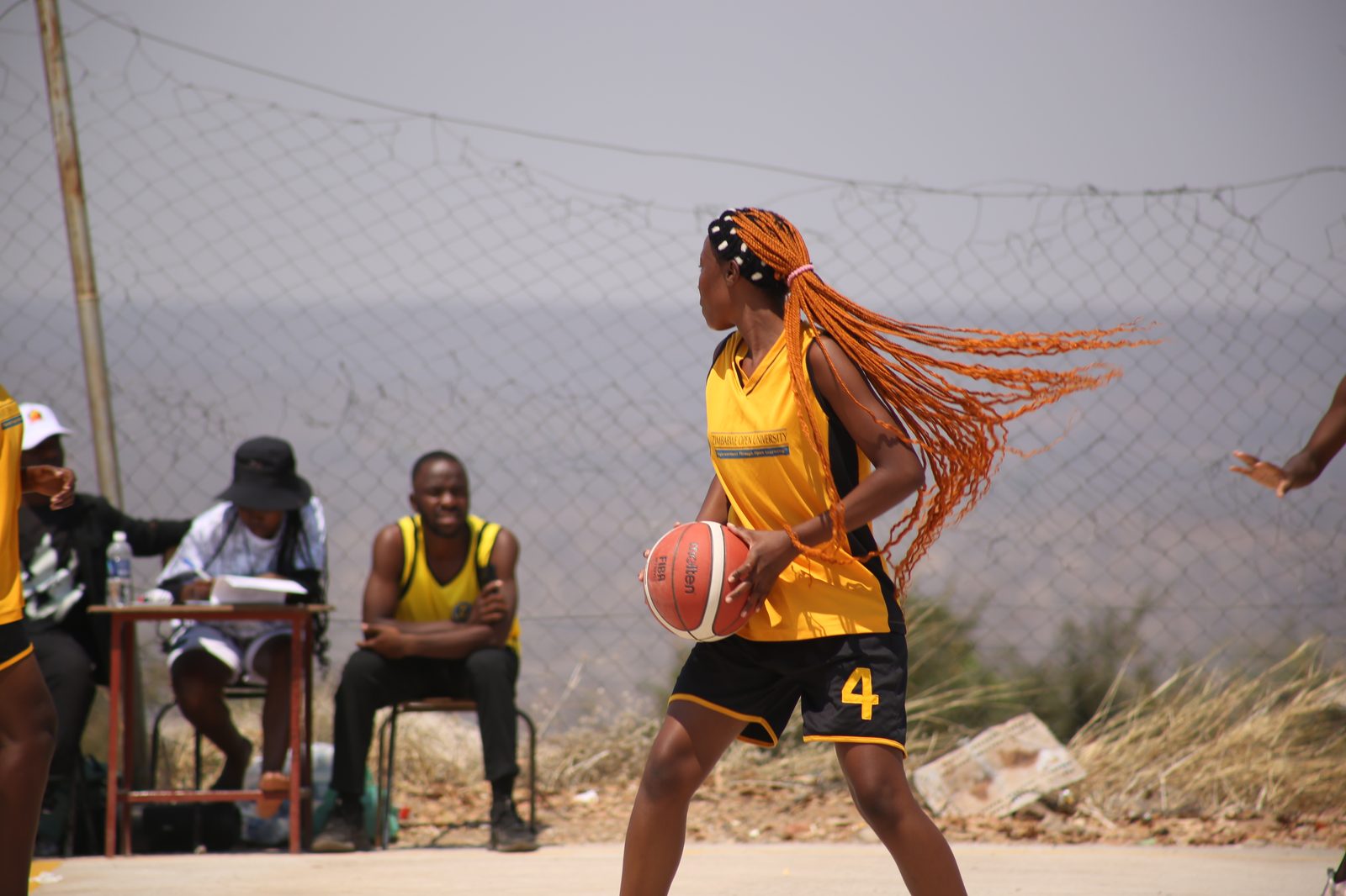 Women's league player drives the ball up court